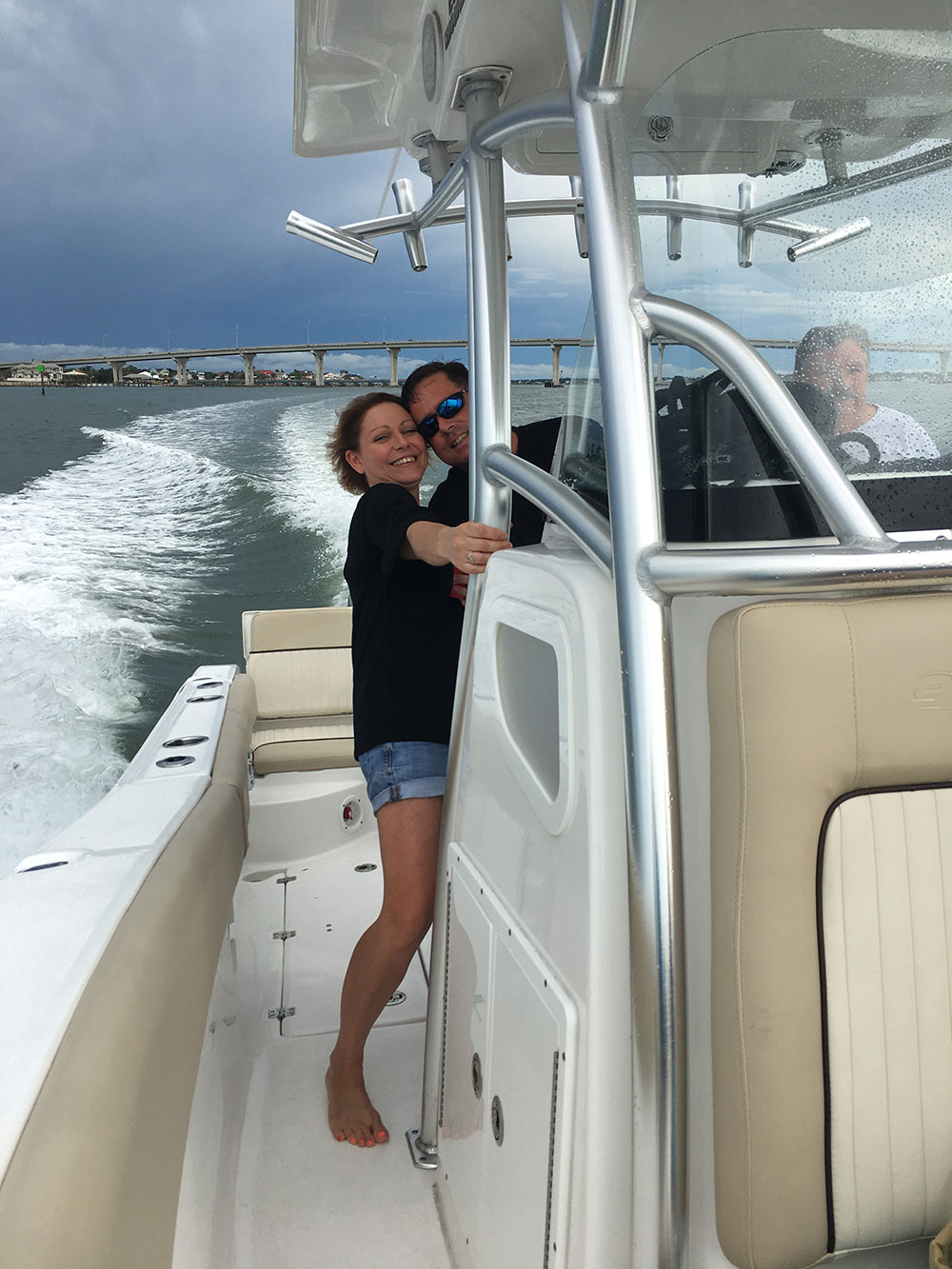 chris worth and his wife smiling on the boat in the intracoastal water