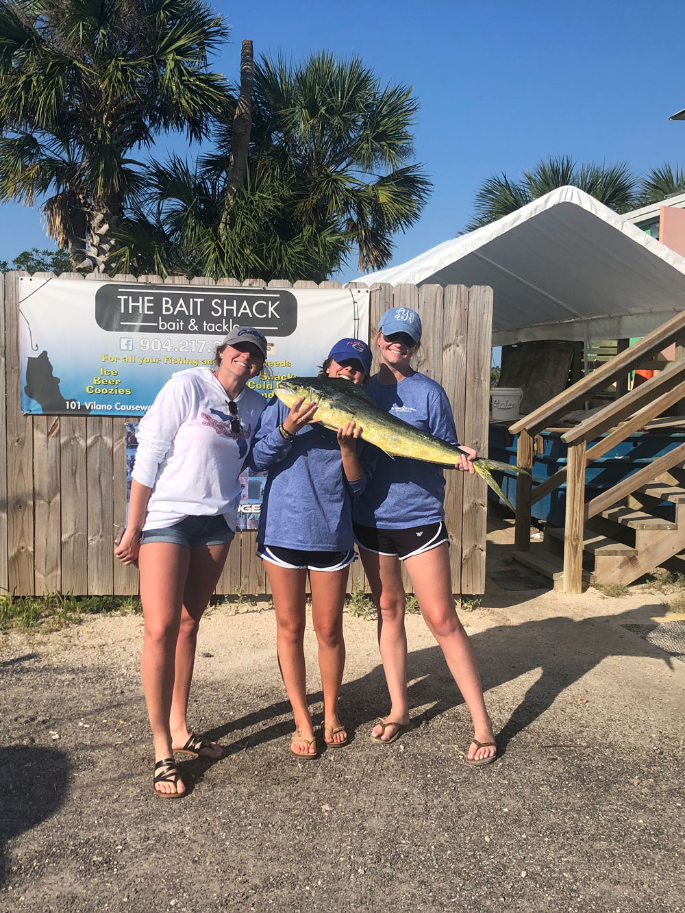 three ladies all holding one fish at The Bait Shack
