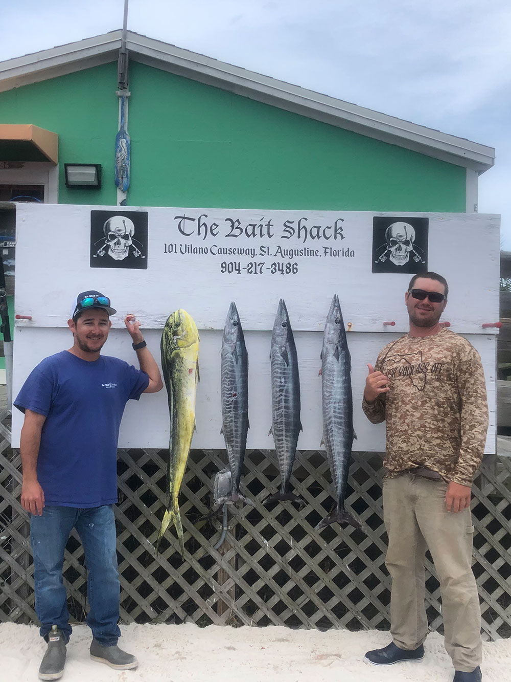 two men showcasing their 4 fish catch at The Bait Shack