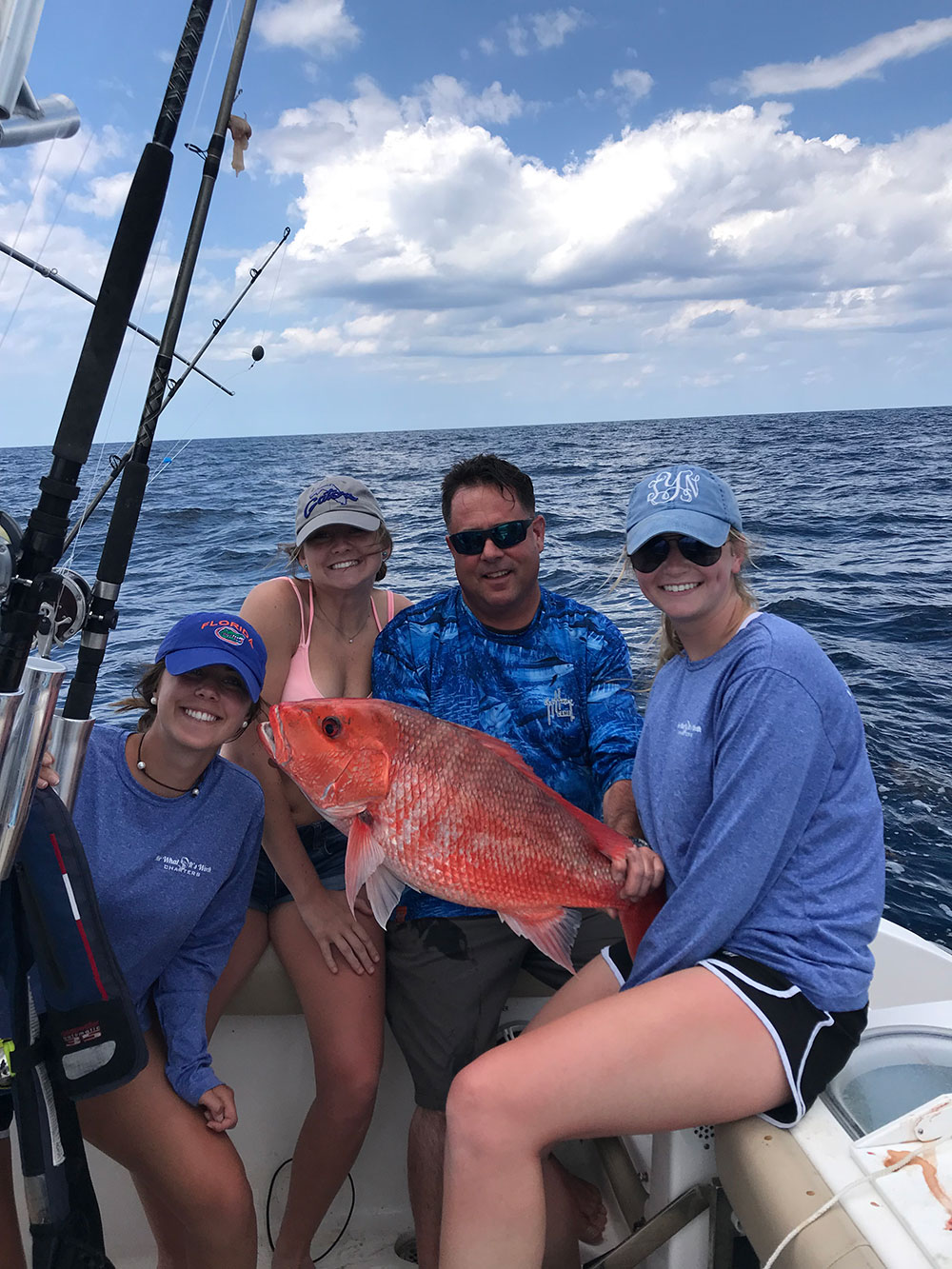 Chris Worth and three ladies showcasing red snapper catch