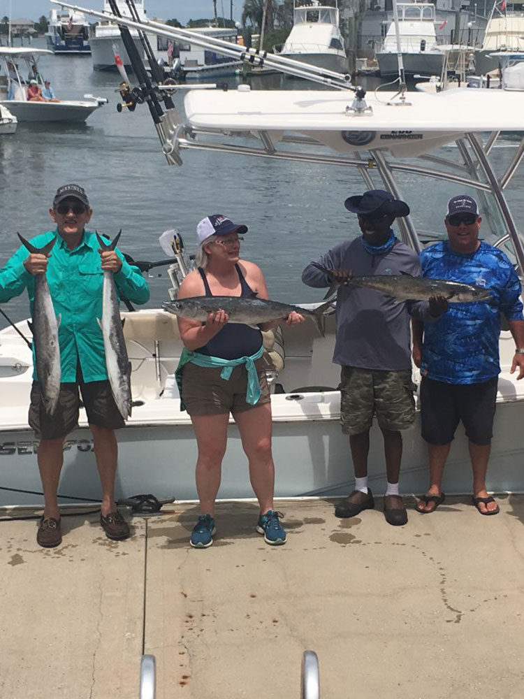 group of guests and Chris Worth holding fish