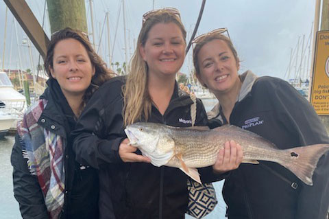 Three women holding a fish